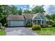 Charming home with blue and gray siding, a two-car garage, and mature landscaping, perfect for suburban living at 109 Gatwick Ct, Statesville, NC 28677