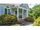 Charming front porch with seating and colorful landscaping, creating an inviting and picturesque curb appeal at 109 Gatwick Ct, Statesville, NC 28677
