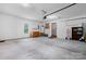 Spacious garage featuring a side entrance, shelving, storage cabinets, and ample space for projects at 109 Gatwick Ct, Statesville, NC 28677