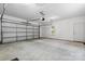 Spacious two car garage with concrete floor, a window for natural light, and a white door at 109 Gatwick Ct, Statesville, NC 28677