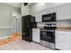 Close-up of kitchen with stainless steel appliances and white cabinets at 109 Gatwick Ct, Statesville, NC 28677