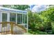 Enclosed sunroom featuring a glass roof and multiple windows with exterior door leading to backyard at 109 Gatwick Ct, Statesville, NC 28677