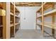Unfinished basement with concrete floor, shelving units, and block wall ready for your customization at 11227 Cool Springs Rd, Cleveland, NC 27013