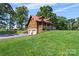 Exterior showing side entry 2-car garage, porch, and manicured lawn at 11227 Cool Springs Rd, Cleveland, NC 27013