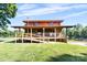 Charming two-story home with rustic wood exterior, open front porch and handicap access ramp at 11227 Cool Springs Rd, Cleveland, NC 27013
