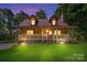 Charming log cabin home featuring a metal roof, covered front porch, and manicured lawn at 11227 Cool Springs Rd, Cleveland, NC 27013