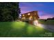 Back view of home with long porch and ramp leading down to the driveway at 11227 Cool Springs Rd, Cleveland, NC 27013