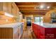 Open kitchen features a stone fireplace, stainless appliances, and large central island with marbled countertops at 11227 Cool Springs Rd, Cleveland, NC 27013