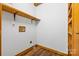 Laundry room with laminate flooring, wooden shelves, and white walls, ready for your appliances at 11227 Cool Springs Rd, Cleveland, NC 27013