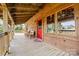 Wide porch with seating, featuring a red door at 11227 Cool Springs Rd, Cleveland, NC 27013