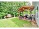 Backyard with wooden deck featuring a covered seating area, grill, and ' playhouse at 120 Tranquil Ct, Locust, NC 28097
