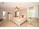 Bright main bedroom features a ceiling fan, carpet, and plenty of natural light at 120 Tranquil Ct, Locust, NC 28097