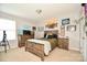 Well-lit bedroom features a window, hardwood furniture, and neutral decor at 120 Tranquil Ct, Locust, NC 28097