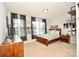 Bright bedroom with a ceiling light, sleek black curtains, and hardwood furniture at 120 Tranquil Ct, Locust, NC 28097