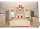 Spacious main bedroom with a ceiling fan and natural light coming from two windows at 120 Tranquil Ct, Locust, NC 28097
