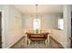 Dining room features wainscoting, wood-look floors, and lots of natural light at 120 Tranquil Ct, Locust, NC 28097