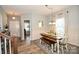 Bright dining room offers wainscoting, wood-look floors, and access to other living spaces at 120 Tranquil Ct, Locust, NC 28097