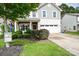 Charming two-story home with stone accents, a two-car garage, and landscaped front yard at 120 Tranquil Ct, Locust, NC 28097