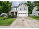 Two-story home with a two-car garage, well-manicured lawn, and a welcoming front porch at 120 Tranquil Ct, Locust, NC 28097
