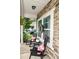 Cozy front porch with stone accents, rocking chairs with floral pillows, and potted plants at 120 Tranquil Ct, Locust, NC 28097