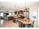 Bright kitchen featuring dark wood cabinets, stainless steel appliances, and an adjacent dining area at 120 Tranquil Ct, Locust, NC 28097