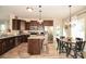 Bright eat-in kitchen features stainless appliances, granite counters, an island, and wood-look floors at 120 Tranquil Ct, Locust, NC 28097