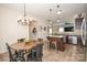Updated kitchen with stainless appliances, granite counters, an island and adjacent dining area at 120 Tranquil Ct, Locust, NC 28097