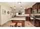 The kitchen features stainless appliances, granite counters, an island, and wood-look floors at 120 Tranquil Ct, Locust, NC 28097