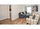 Inviting living room with sleek hardwood floors and comfortable blue and patterned furniture at 120 Tranquil Ct, Locust, NC 28097