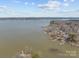 Aerial view shows homes with lake access and docks, set against a backdrop of blue sky at 132 Swimmers Ln, Salisbury, NC 28146