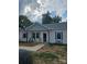 Inviting single-story home featuring a charming front porch and manicured lawn at 132 Swimmers Ln, Salisbury, NC 28146