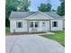 Charming single-story home with a covered porch, tidy yard, and concrete driveway at 132 Swimmers Ln, Salisbury, NC 28146
