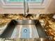 Close up shot of the kitchen sink featuring granite counters and stainless steel faucet at 132 Swimmers Ln, Salisbury, NC 28146