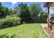 Expansive backyard featuring a lush green lawn and mature landscaping, perfect for outdoor activities and relaxation at 1458 Bedlington Nw Dr, Charlotte, NC 28269