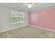 Bright bedroom with large window and colorful accent stripe at 1458 Bedlington Nw Dr, Charlotte, NC 28269