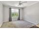 Comfortable bedroom with ample natural light from large window and ceiling fan at 1458 Bedlington Nw Dr, Charlotte, NC 28269