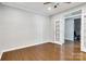 Bedroom with hardwood floors, white trim, and double french doors leading to another room at 1458 Bedlington Nw Dr, Charlotte, NC 28269