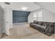 Cozy bonus room with blue accent wall, carpet, and modern lighting at 1458 Bedlington Nw Dr, Charlotte, NC 28269