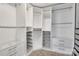 Spacious walk-in closet with custom white shelving, drawers, and ample storage space for organization at 1458 Bedlington Nw Dr, Charlotte, NC 28269