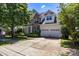 Traditional two-story home with a brick and siding facade, a well-maintained lawn, and an attached two-car garage at 1458 Bedlington Nw Dr, Charlotte, NC 28269