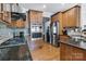 Kitchen featuring stainless steel appliances, wood cabinets, and black countertops at 1458 Bedlington Nw Dr, Charlotte, NC 28269