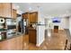 Open kitchen with stainless steel appliances connects to a cozy living area at 1458 Bedlington Nw Dr, Charlotte, NC 28269