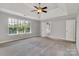 Spacious main bedroom features a tray ceiling, large window, and ensuite bathroom access at 1458 Bedlington Nw Dr, Charlotte, NC 28269