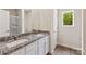 Bathroom featuring double sink, granite countertops, white cabinets and framed mirror at 1510 Doran Ter, Richburg, SC 29729