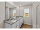 Bathroom vanity featuring granite counters, double sinks, and views of a green yard at 1512 Doran Ter, Richburg, SC 29729