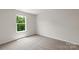 Bedroom with carpet, and a large window overlooking lush greenery at 1512 Doran Ter, Richburg, SC 29729
