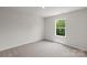Bedroom with neutral carpet, fresh paint, and a window overlooking lush greenery at 1512 Doran Ter, Richburg, SC 29729