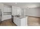 Bright kitchen featuring an island with seating, granite countertops, and wood flooring at 1512 Doran Ter, Richburg, SC 29729