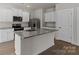 Modern kitchen featuring an island with granite countertops, stainless steel appliances, and white cabinets at 1512 Doran Ter, Richburg, SC 29729