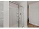 Shower featuring white tile, glass doors, built in shelves, and modern fixtures at 1512 Doran Ter, Richburg, SC 29729